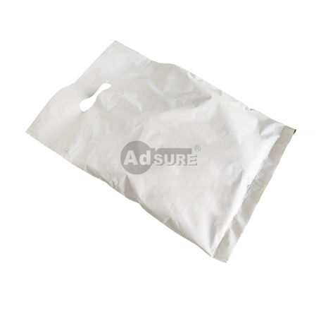 Flat lay of a single white coex hand-hole auto-bag, highlighting the durable film quality and precision die-cut handle design.