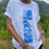 Thumbnail: WE CALL IT HOLY WATER Triptych Shirt