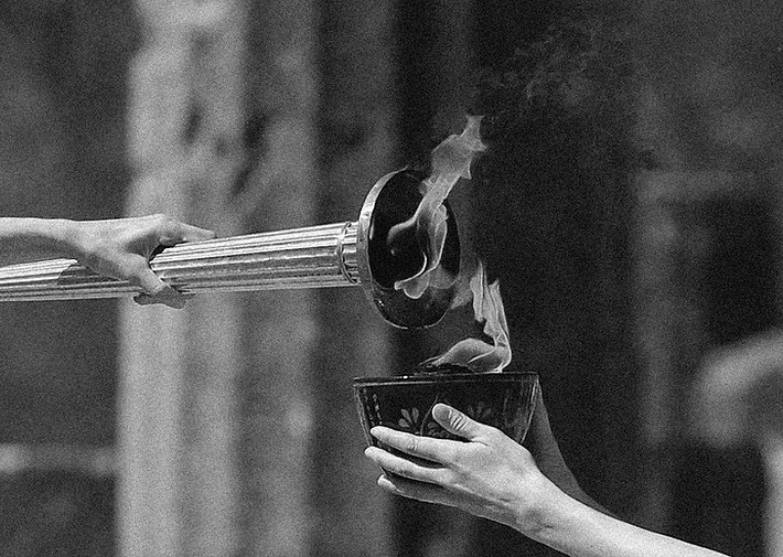 image of the olympic torchbeing lit, a symbol of the moot competition and the values of sports arbitration