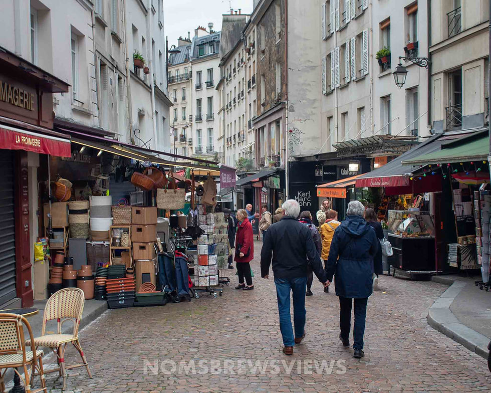 people filling the streets of a lively paris market