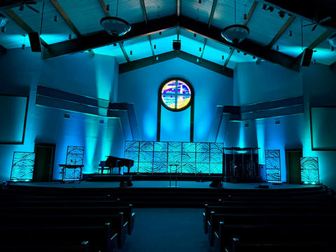 large portable backdrop panels featuring ocean waves cover set with blue LED lighting behind it. 