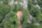 Aerial view of a cleared residential lot and access route.
