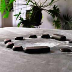 Close-up view of a massage table with soft linens in a calm room