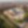 hyperrealistic photography of a museum seen from a drone in a modern city. There is presen
