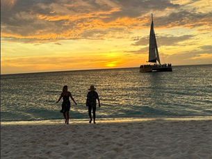 Aruba sunset, people walking on beach
