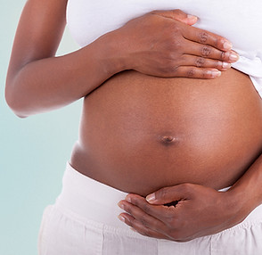 Pregnant woman with morning sickness seeing a qualified acupunctrist