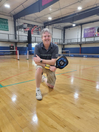 This is a pickleball player wearing a pickleball scorekeeper called "Pickle Pal."