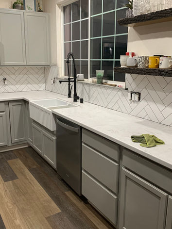 modern farmhouse, white counter tops, tile, marble countertops, farmhouse, barn conversion, flooring installation, appliance installation, black faucet, farmhouse sink, custom tile backsplash