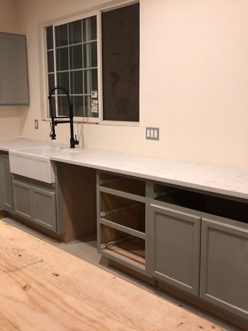 barn conversion, barn to home, full construction, cabinet installation, kitchen cabinet installation, kitchen island installation, farmhouse sink, white sink with black faucet, farmhouse kitchen remodel