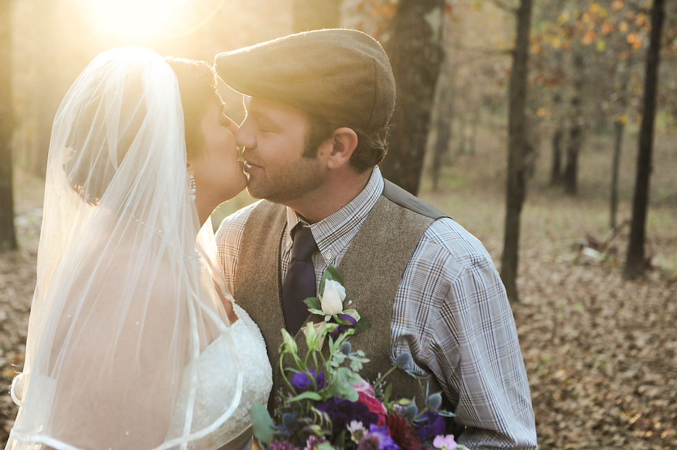 Bride and groom sharing a kiss in golden sunlight