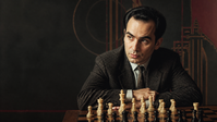 Editorial portrait of Mikhail Tal seated at a chessboard, created for his chess biography