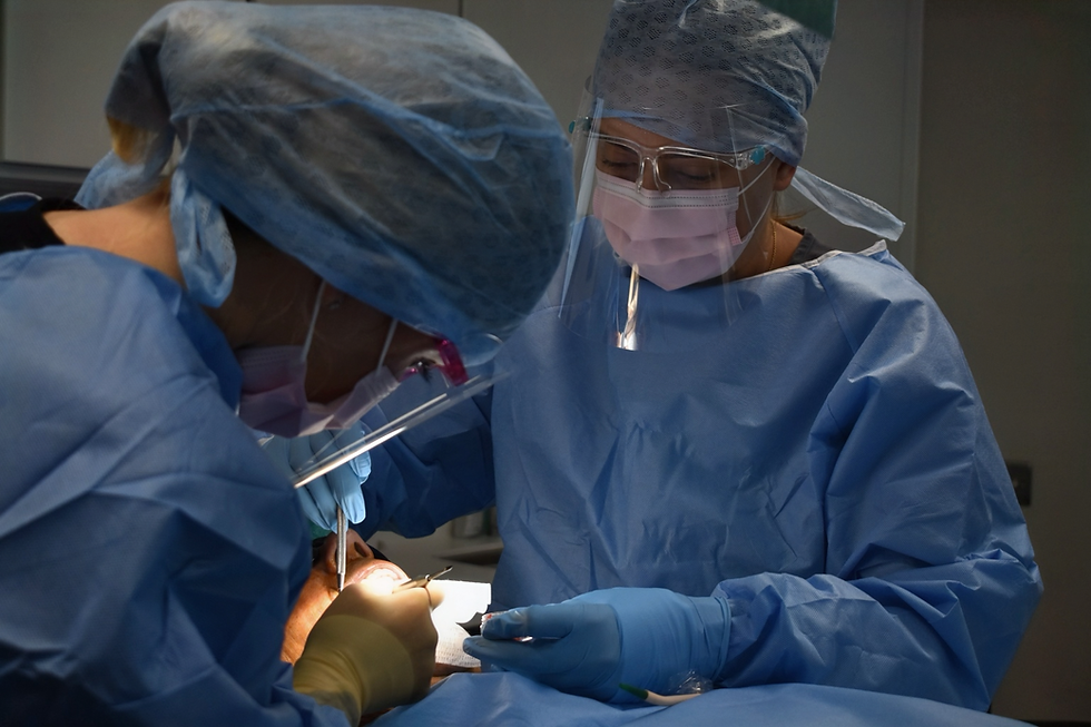 Dental nurse assisting during a surgical procedure