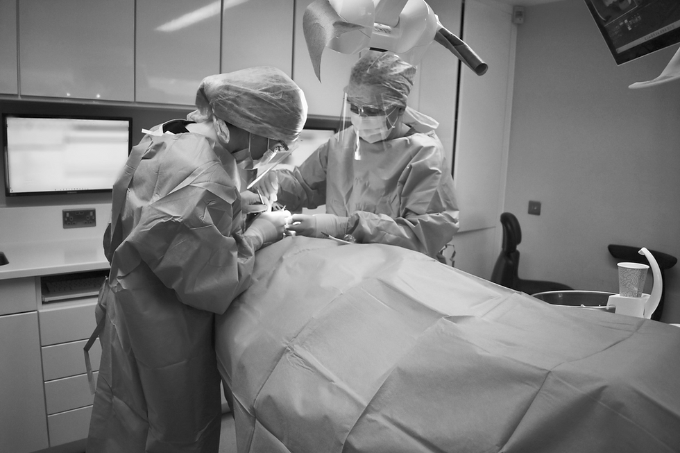 Oral surgeons performing dental implant procedures.