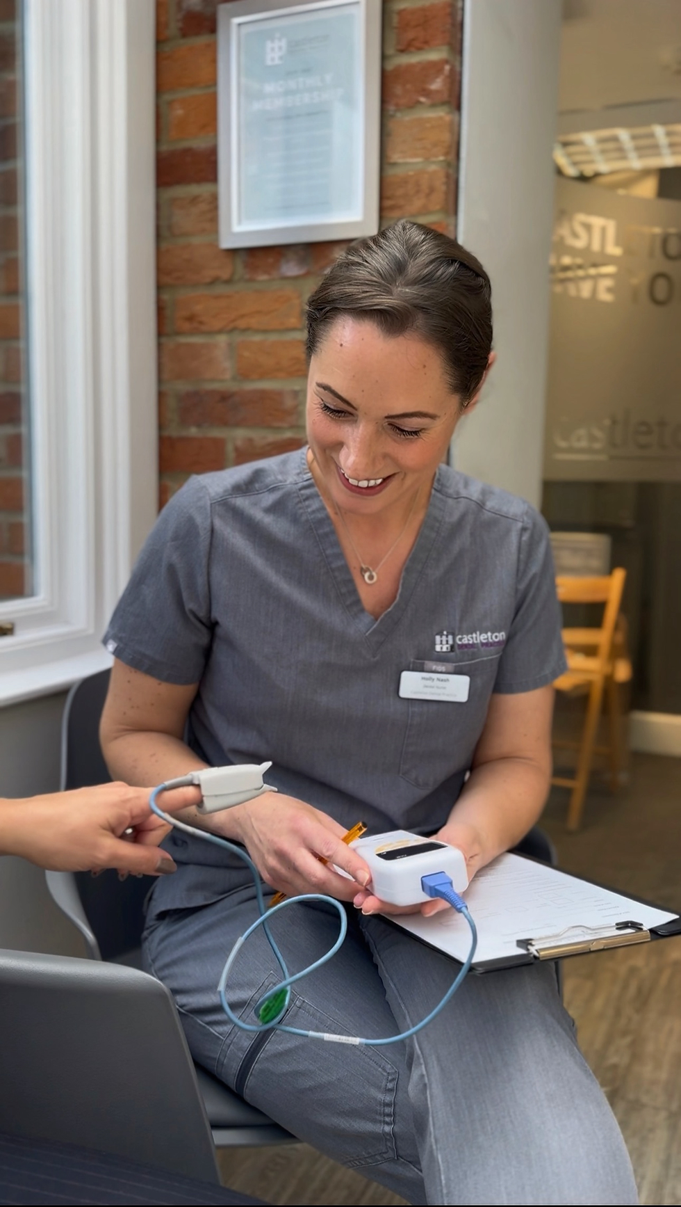 Dental & sedation nurse Holly N monitoring a patient