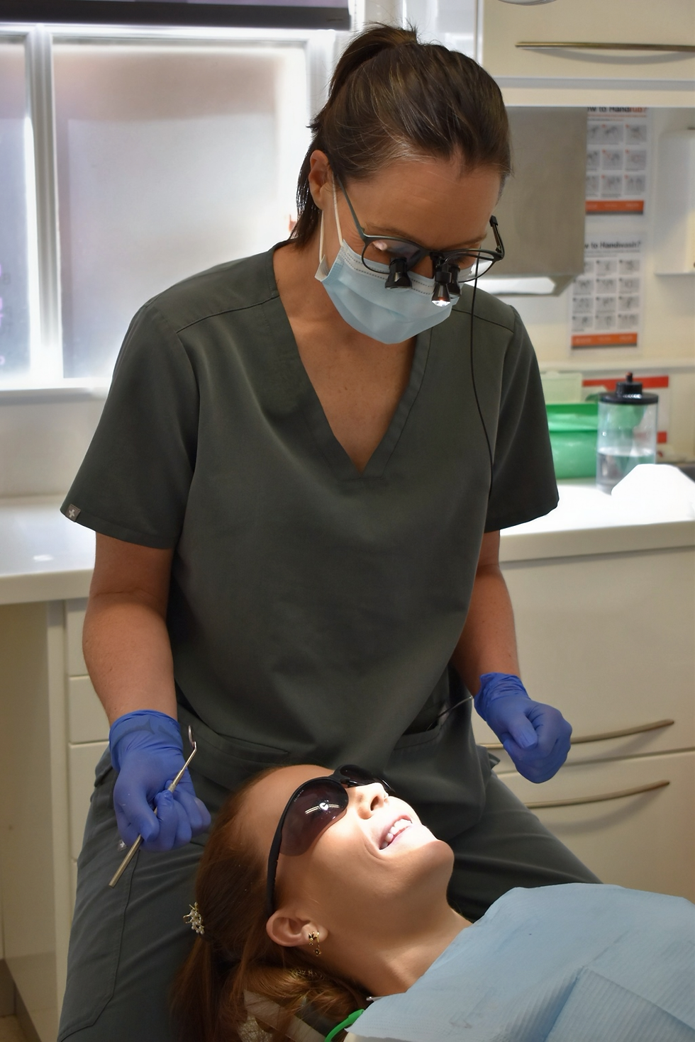 Dental hygienist Katy performing a check-up on a patient.