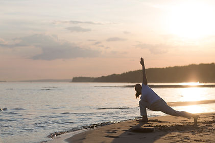 Woman praticing yoga  at sunset on the beach. Chinese management skill Qi's energy. solo o