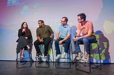 Sage speaking on stage during a panel.