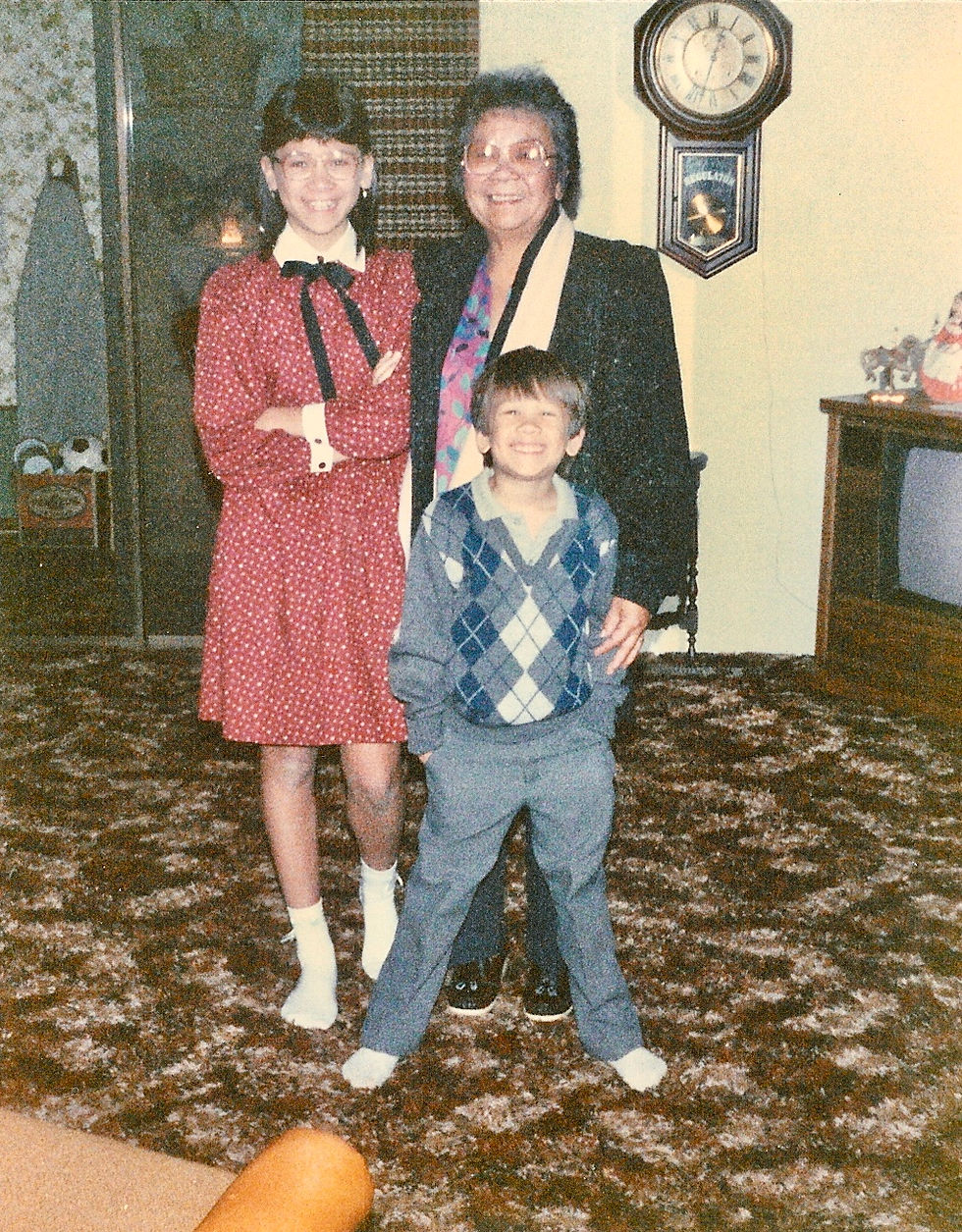 Three people standing in a living room