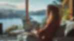young-woman-sitting-couch-using-laptop-home-she-is-looking-out-beautiful-view-lake-mountai
