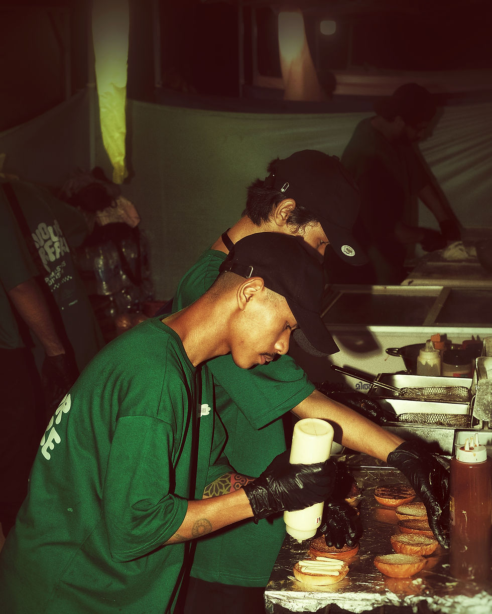 Chefs making a burger on the stove