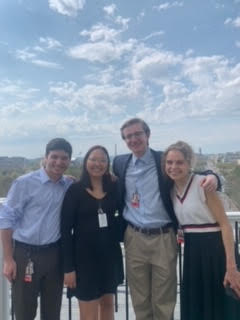 Becca and three of her fellow interns posing together in front of the DC skyline with the Washington Monument in the background.