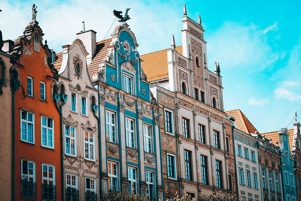 Colorful historic merchant houses with ornate gables and a blue sky in Gdańsk Poland city center