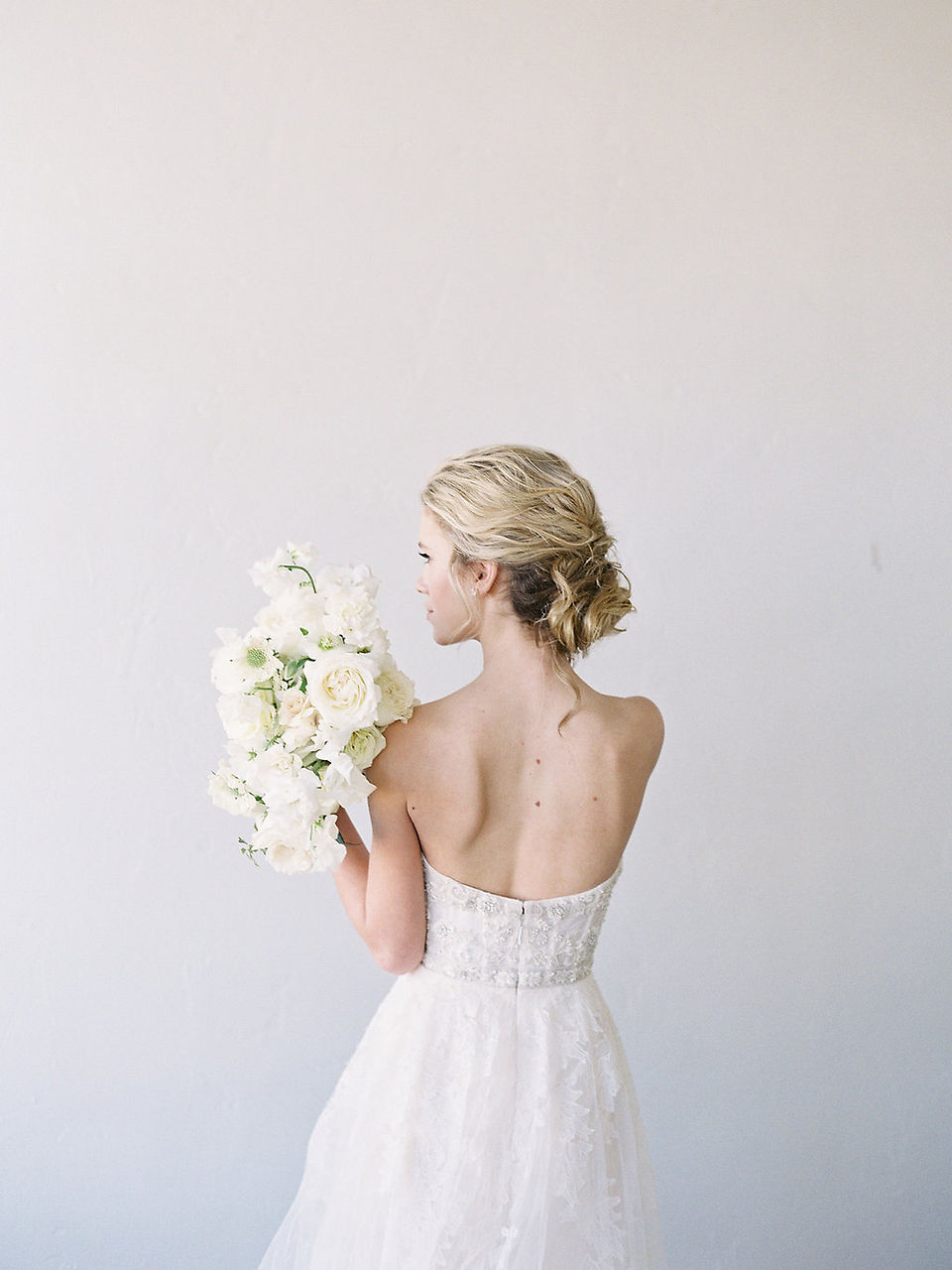 Bride holding white bouquet of flowers