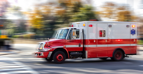 Ambulance responding to emergency, representing accidental death insurance coverage that provides financial protection in une
