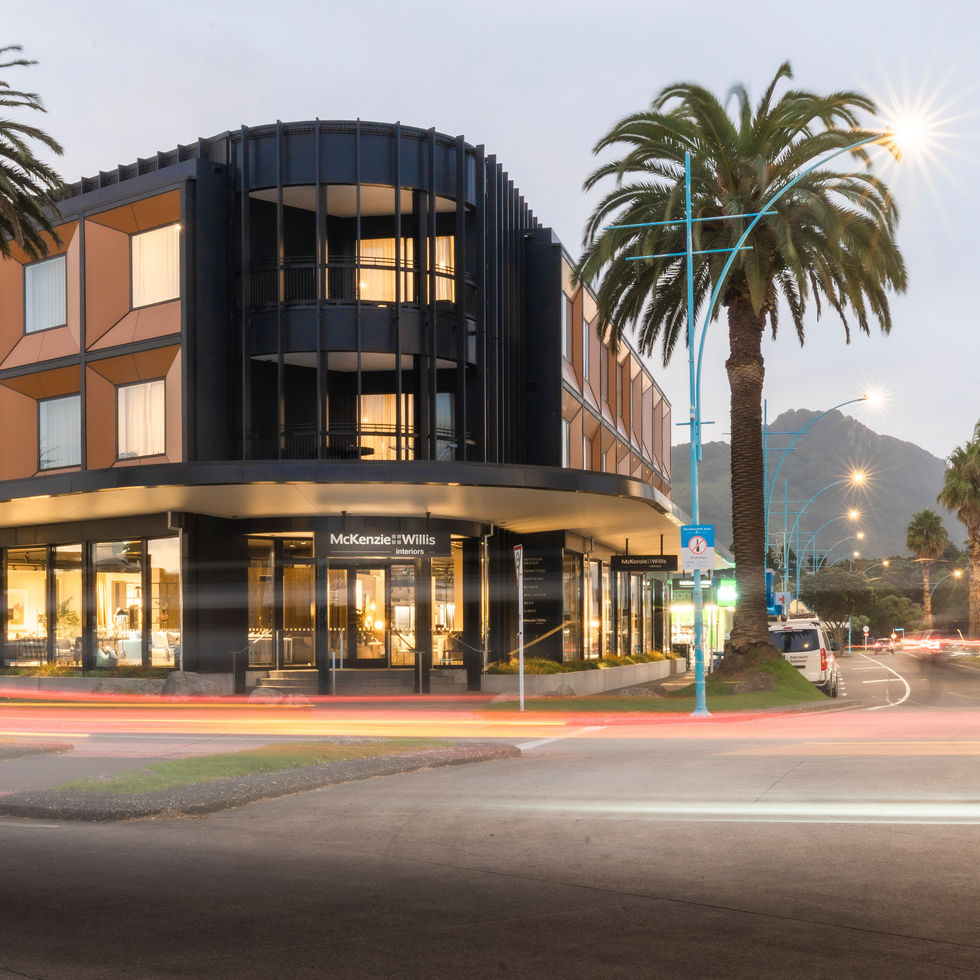 Cozy living room with neutral tones, furniture, rug, and natural lighting.