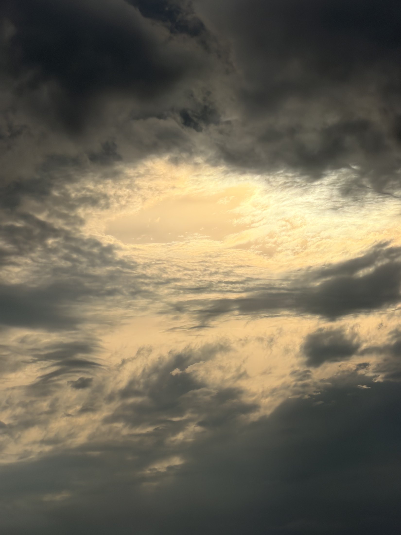 Original travel photograph: sunlight opening through a dramatic sky