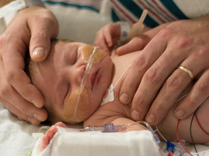 A father holding his beautiful baby in the neonatal intensive care unit