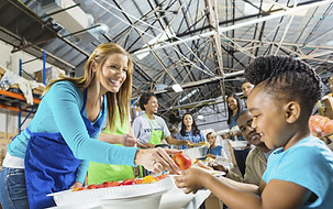 Volunteers Serving Food to children
