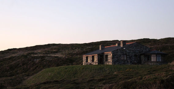 Ancienne maison ou ruine en pierre traditionnelle nichée à flanc de colline le long de la Sky Road dans le Connemara en Irlande.