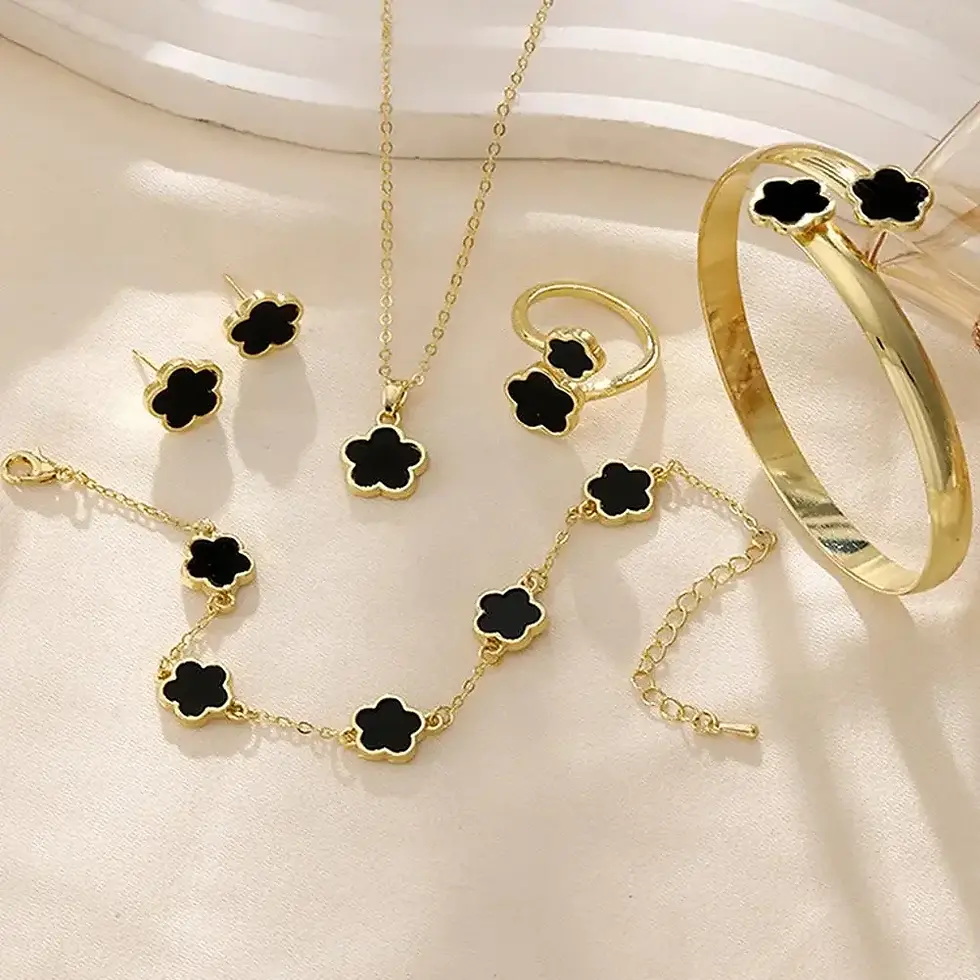 Thumbnail: Gold jewelry set with black clover design.