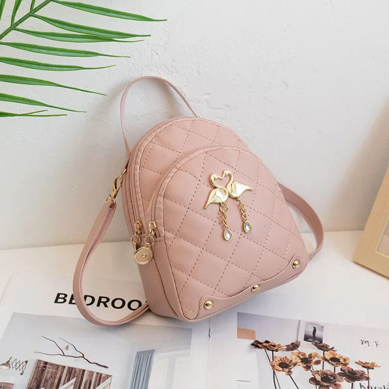 Thumbnail: Pink quilted backpack with decorative charm