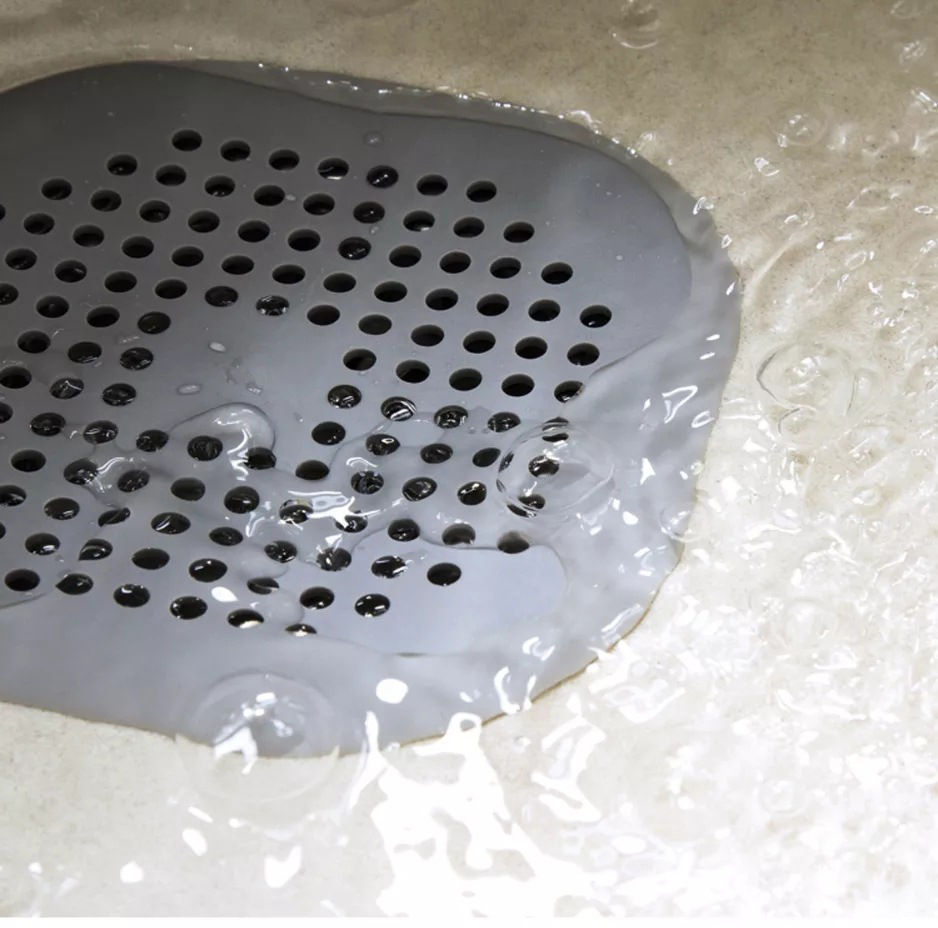 Thumbnail: Water flowing over a gray drain, close-up shot