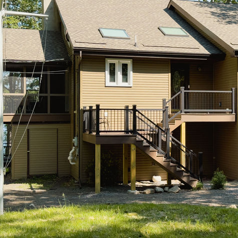 front stairs and screened patio of a lake front property.