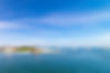 Lighthouse and sailboats under a blue sky day in the Nantucket Harbor..jpg