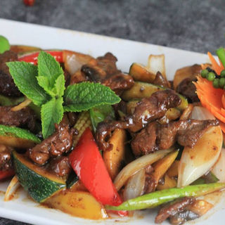 Close-up of oyster stir fry with glossy sauce and fresh vegetables