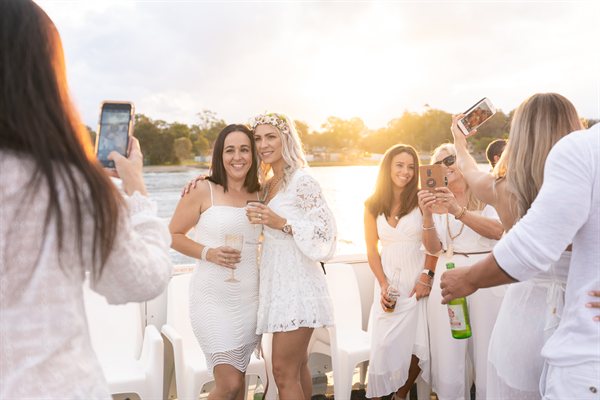 Hens party group on Island Party Cruiser sundeck at sunset