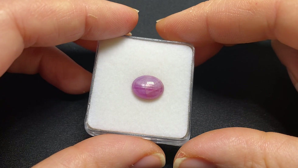 Thumbnail: Close-up of the pink star sapphire showing its translucent body and six-ray star.