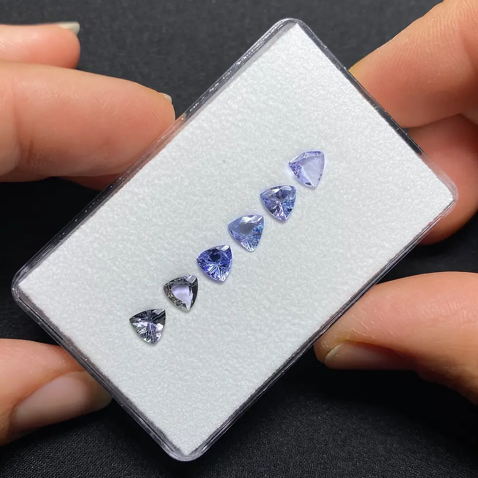 Thumbnail: Alternate view of the six trillion-cut tanzanites highlighting their colors and facets.