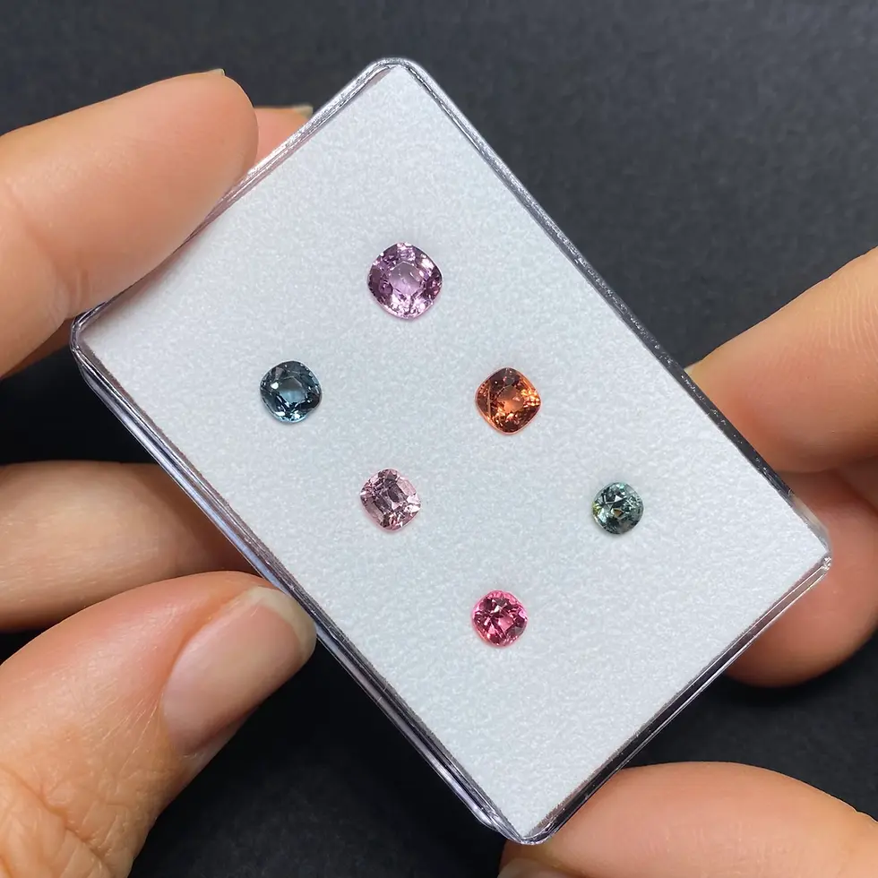 Thumbnail: Alternate view of the Mogok spinels highlighting their individual colors and faceted surfaces.