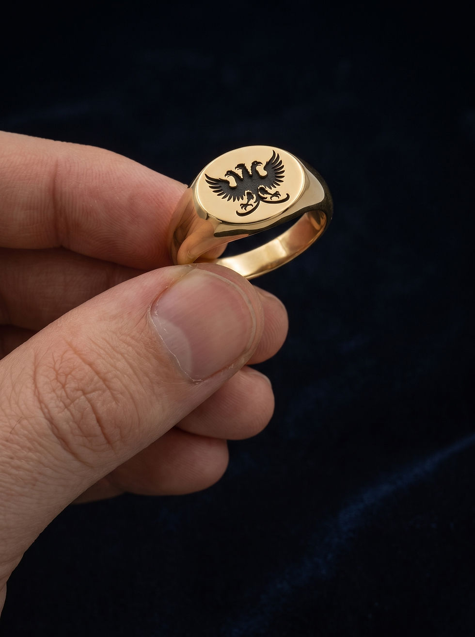 Alternate view of the gold signet ring showing its face and sculptural shoulders.