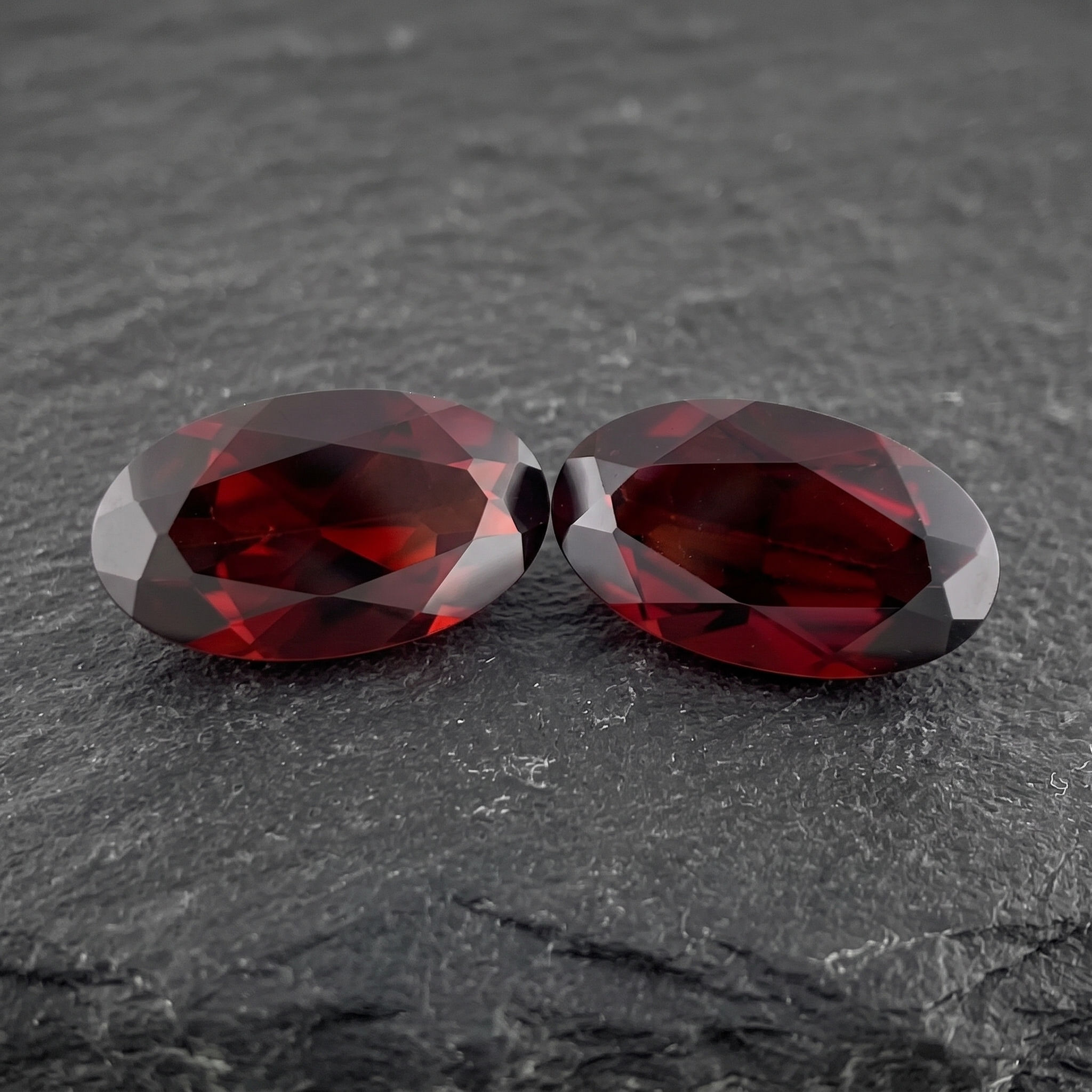 Matched pair of natural Mozambique chrome pyrope garnets totaling 6.975 ct, with vivid blood-red color.