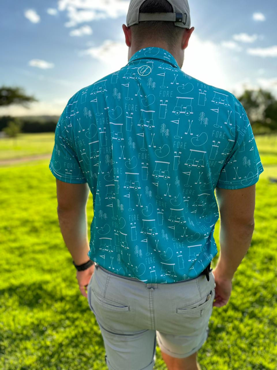 Thumbnail: UnderPAR Golf Shirt Teal Fore Range man walking on golf course facing away