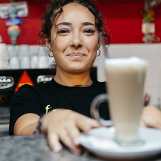 girl serving a cafe latte