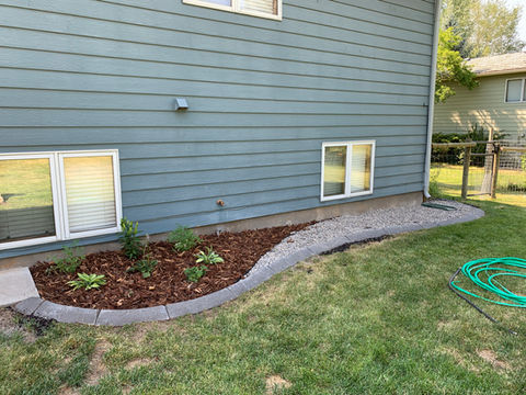 Backyard garden bed with rock and mulch in Bozeman, MT