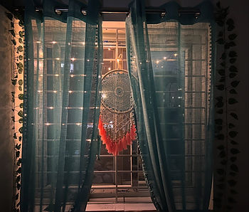 an aesthetic window with dream catcher