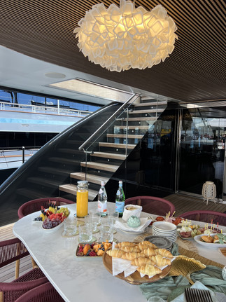 Luxury yacht REPOSADO and her welcoming deck with snacks